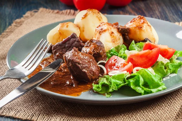 Varkensvlees vlees stoofpotje, geserveerd met aardappelen en groente salade — Stockfoto