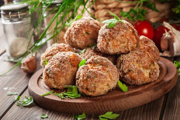 Stack of baked meatballs on a chopping board — Stock Photo, Image