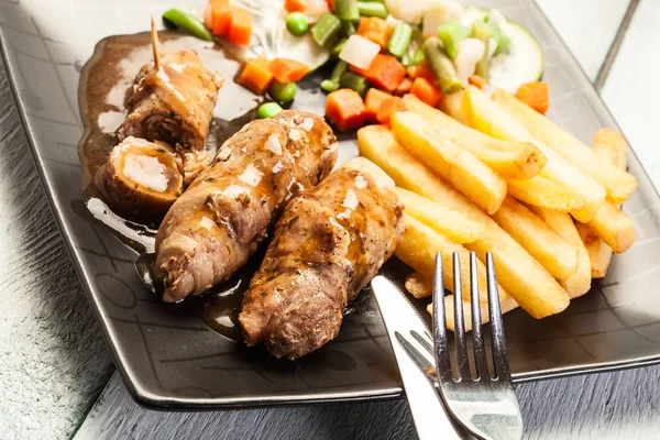 Pork rolls with french fries with vegetable — Stock Photo, Image