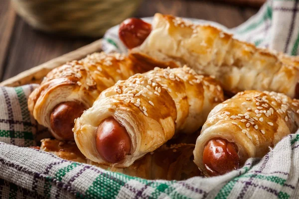 Rolled hot dog sausages baked in puff pastry — Stock Photo, Image