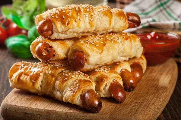 Rolled hot dog sausages baked in puff pastry — Stock Photo, Image