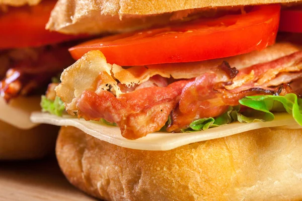 Ciabatta sandwich with smoked bacon, cheese and tomato — Stock Photo, Image