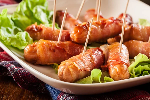 Pigs in blankets on a plate — Stock Photo, Image