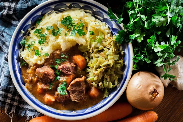 Traditional irish stew served with potatoes and cabbage — Stock Image Traditional irish stew served with potatoes and cabbage Stock Photo