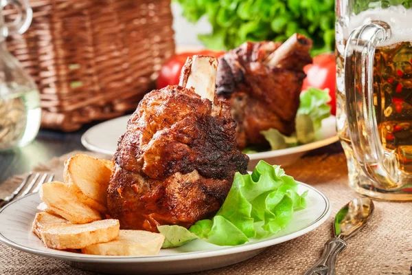 Roasted turkey knuckle with fried potato slices — Stock Photo, Image