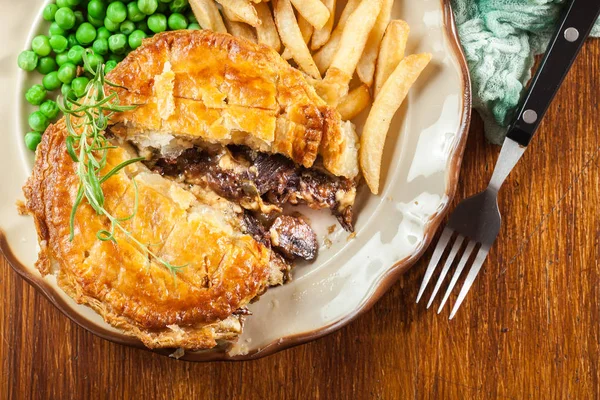 Homemade beef stew pie with french fries