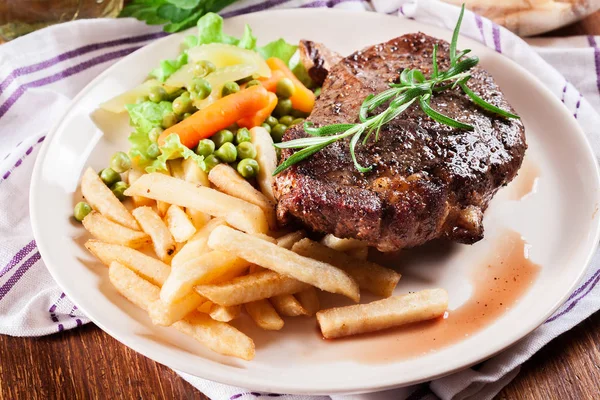 Beef steak served with baked potatoes — Stock Photo, Image