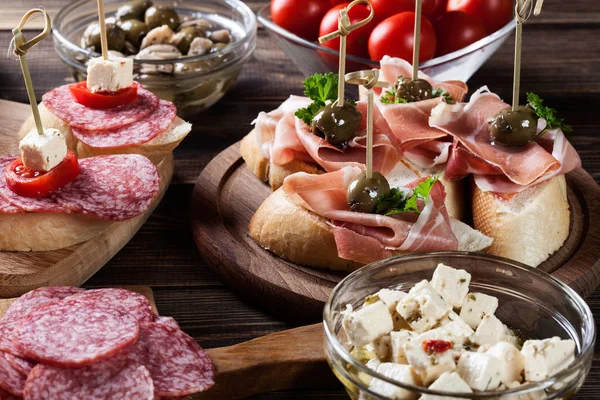 Spanish tapas with slices jamon serrano, salami, olives and chee