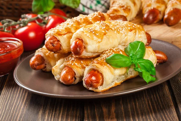 Rolled hot dog sausages baked in puff pastry — Stock Photo, Image