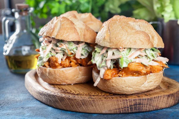 Pulled chicken sandwich with salad and bbq sauce