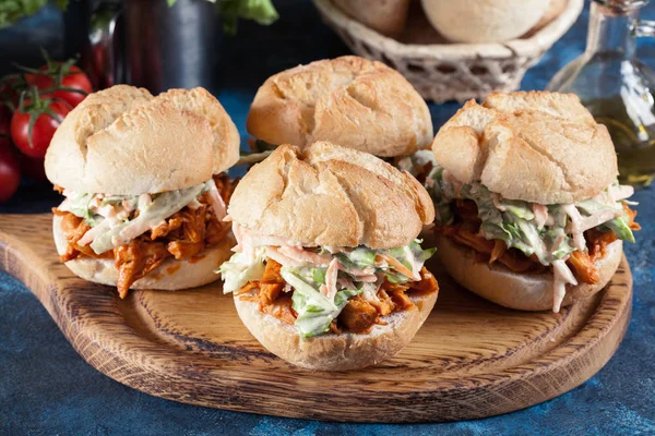 Pulled chicken sandwich with salad and bbq sauce