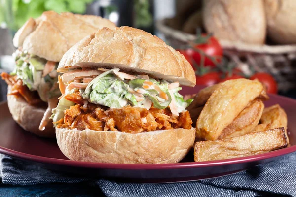 Pulled chicken sandwich with salad and bbq sauce