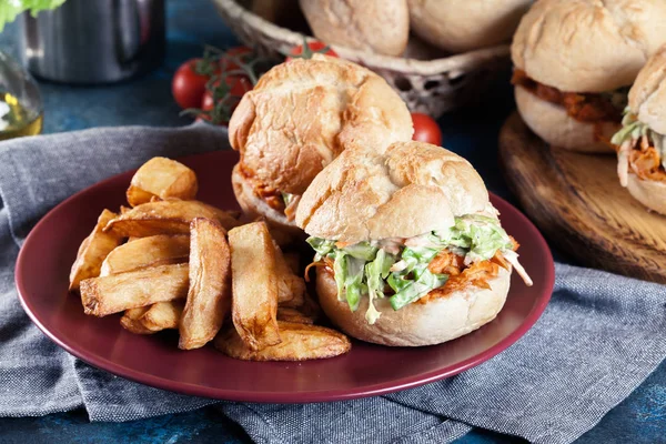 Pulled chicken sandwich with salad and bbq sauce