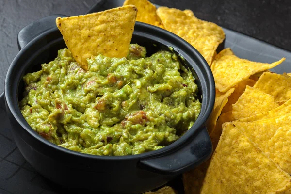 Bowl of guacamole with corn chips — Stock Photo, Image