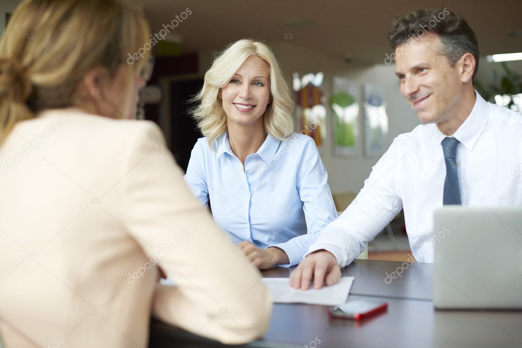  woman consulting  middle aged couple a