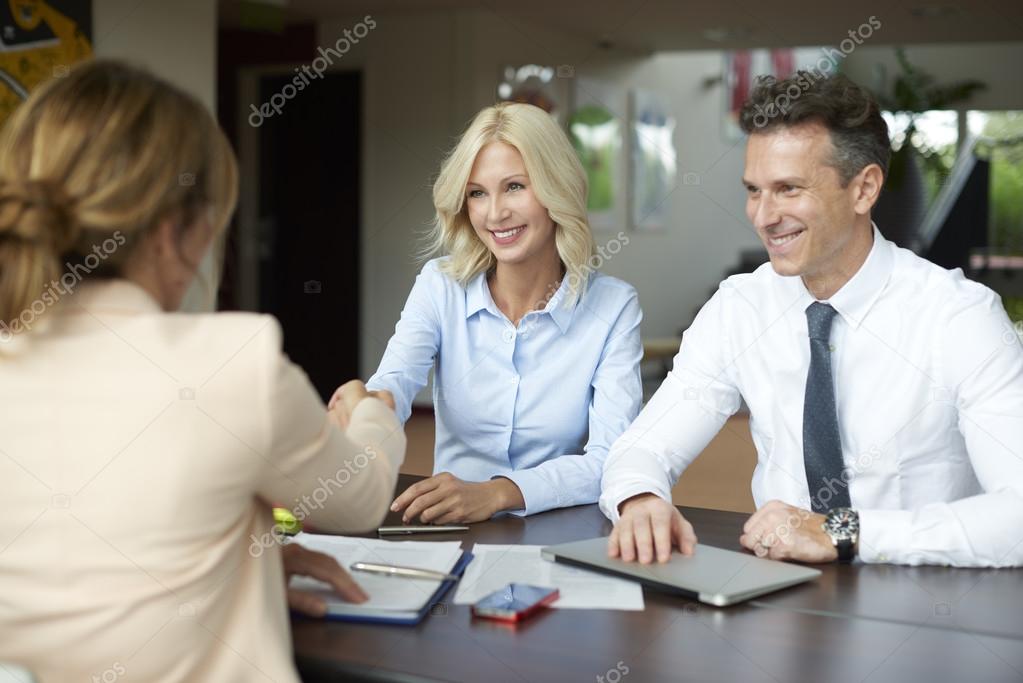  manager shaking hands with smiling woman