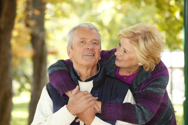 Mujer abrazando viejo hombre . — Foto de Stock