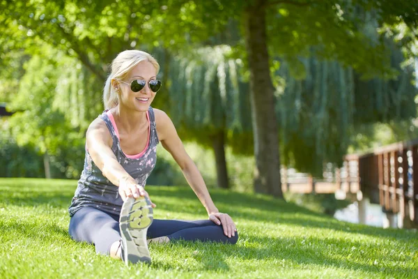 Mujer estirándose antes de correr —  Fotos de Stock