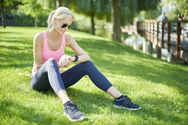 Woman sitting after morning workout — Stock Photo, Image