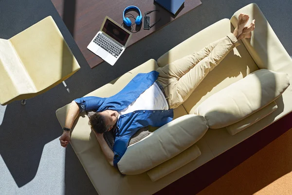 Relaxed man on couch at home — Stock Photo, Image