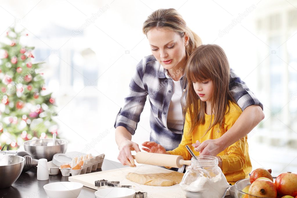 daughter and  mom baking cookies 