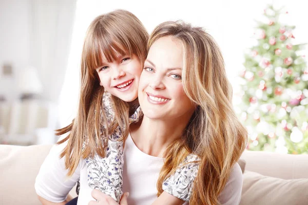 Girl hugging her happy mother — Stock Photo, Image