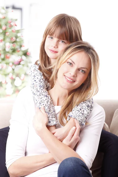 Girl hugging her happy mother — Stock Photo, Image