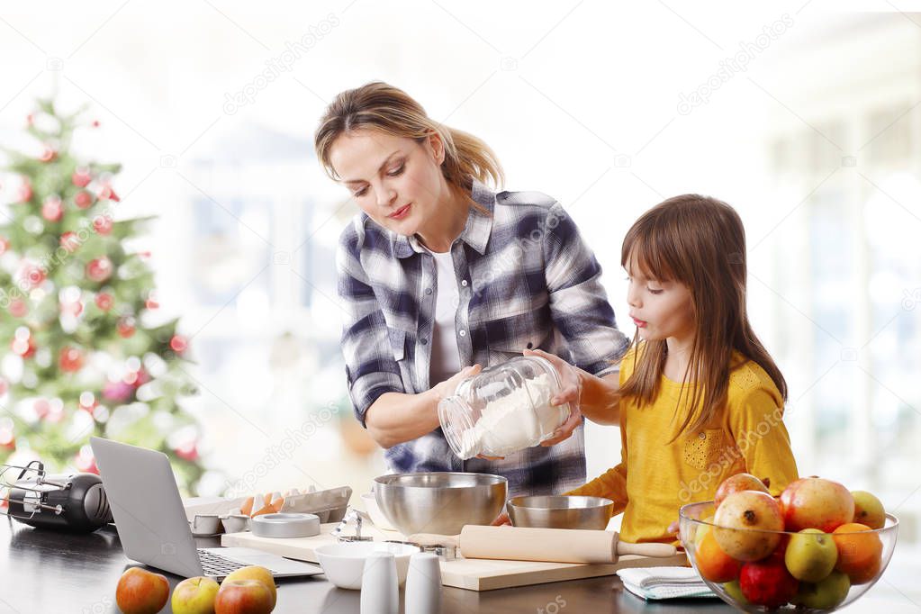 mother and her cute daughter baking
