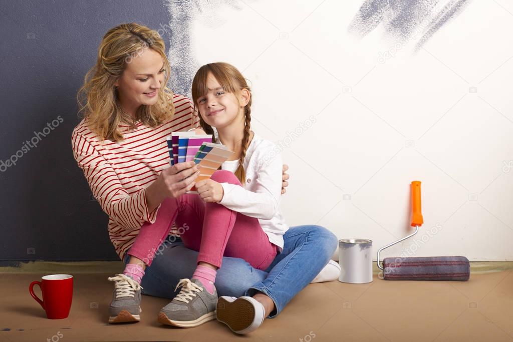  mother sitting with her cute daughter
