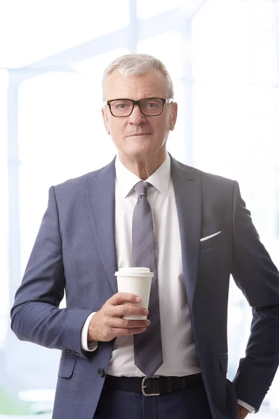 Businessman holding a cup of coffee — Stock Photo, Image