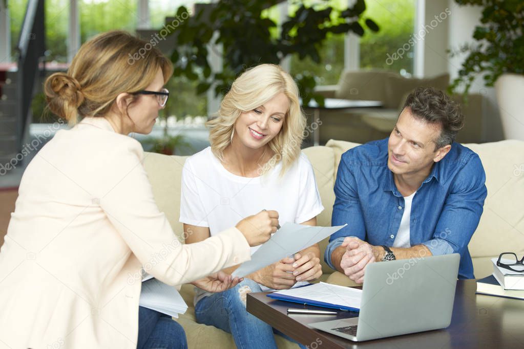 couple consulting with real estate agent 