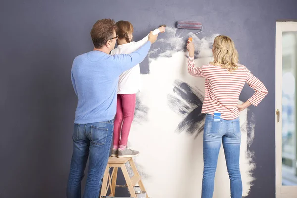 happy family painting wall