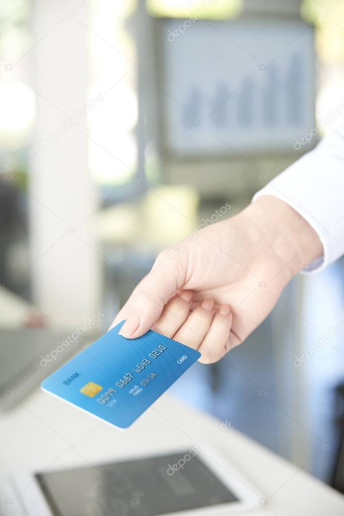  businesswoman  holding credit card in her hand. 