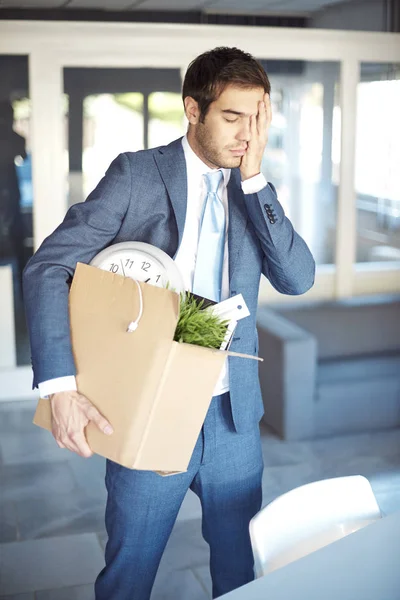 Businessman carrying cardboard box — Stock Photo, Image