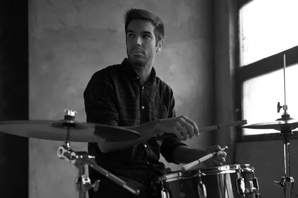 drummer playing her drum set and practicing.