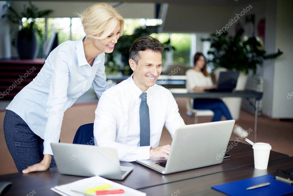 businessman sitting at office in front of laptop