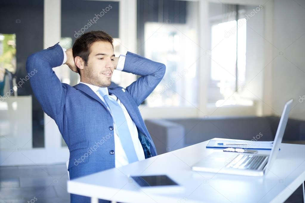 businessman sitting in front of his laptop