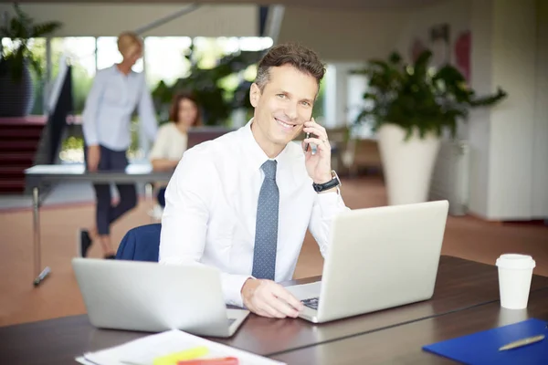 Confident businessman using with laptop — Stock Photo, Image