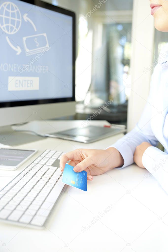 Shot of a businesswoman  holding bank card and making online payments by credit card.