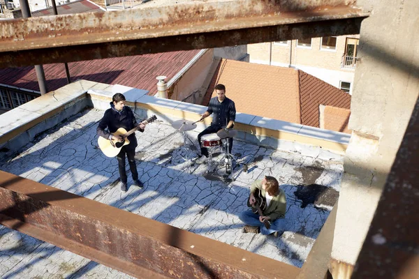 boyband playing on the roof top.