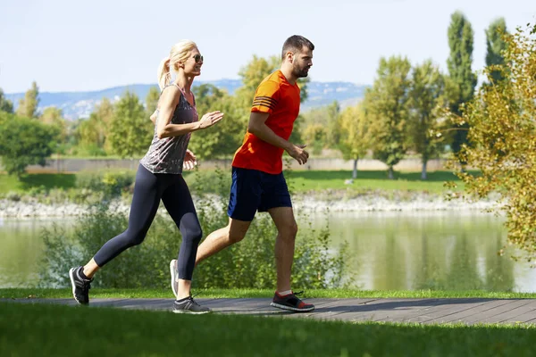 Mulher e homem correndo ao ar livre . — Fotografia de Stock