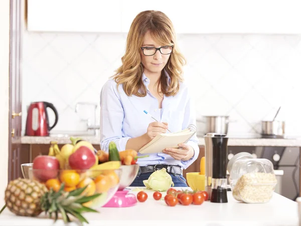 Woman writing recipe — Stock Photo, Image