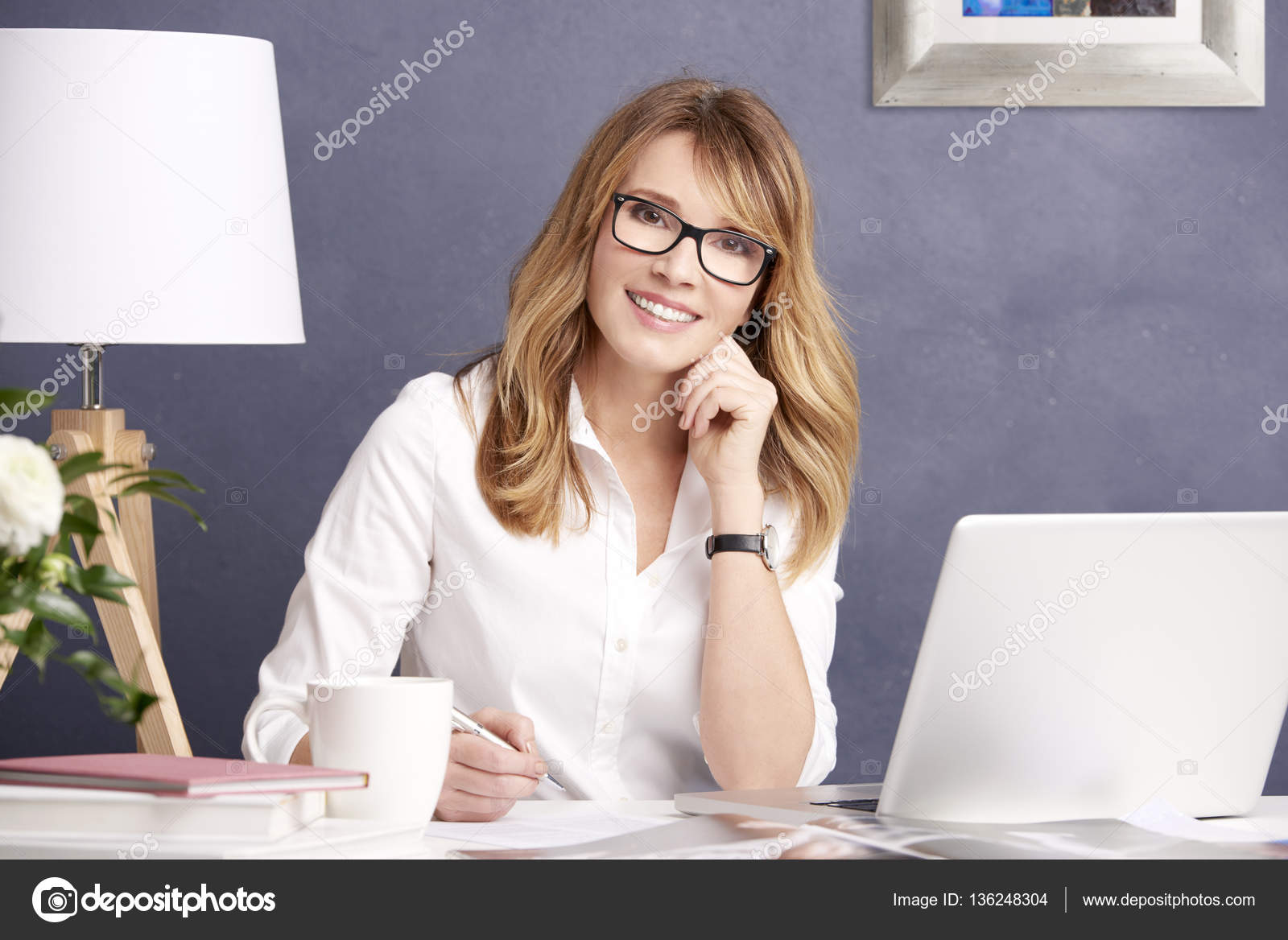 Editor in chief woman using her laptop Stock Photo by ©Sepy 136248304