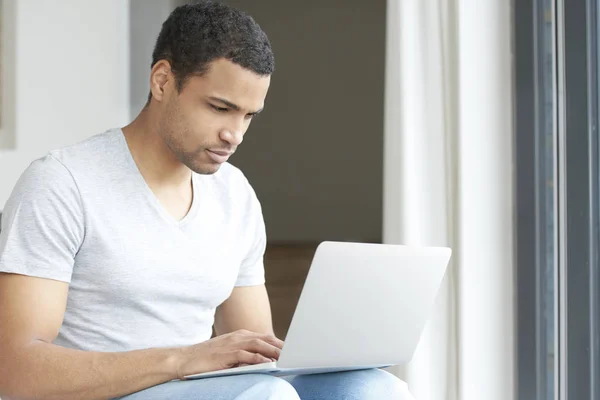 Man using his laptop while relaxing — Stock Photo, Image