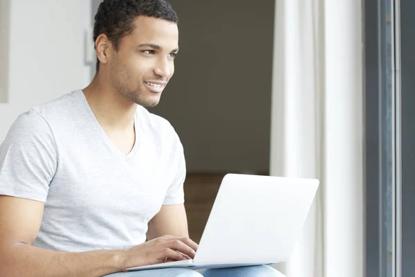 Young man using his laptop — Stock Photo, Image