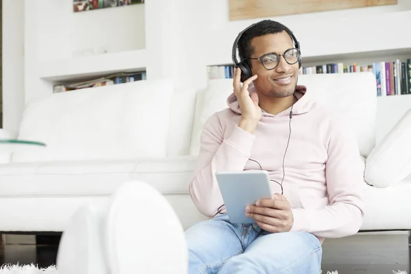 Mannen med tablett lyssnar på musik — Stockfoto