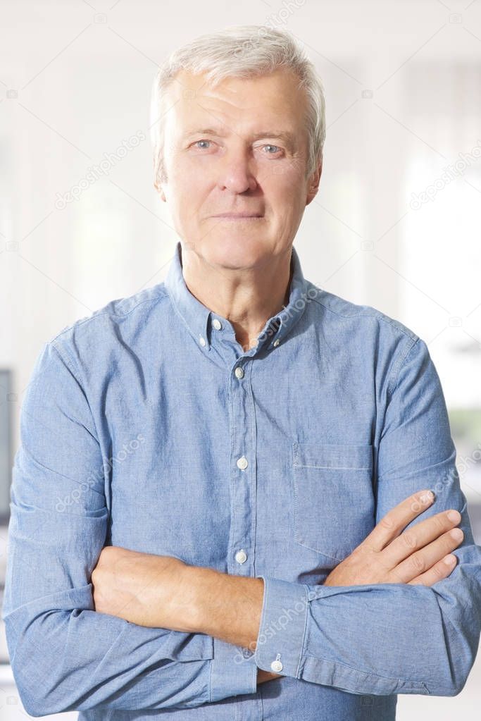 elderly businessman standing 