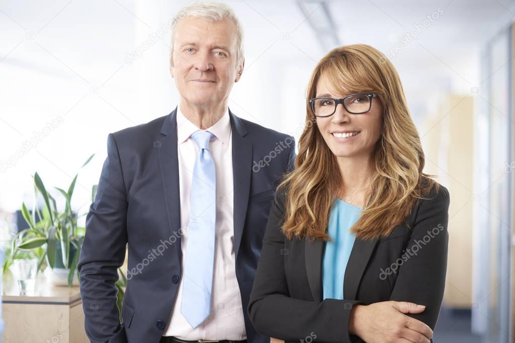 businesswoman and a senior businessman standing