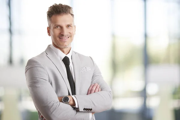 businessman standing with arms crossed
