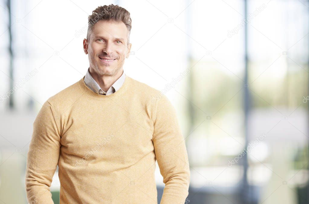 A casual man standing inside